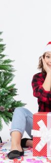 front view young female sitting around presents holding envelop on white background holiday snow emotion christmas new year